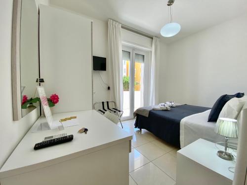 a bedroom with a bed and a desk with a keyboard at B&B ARFE' in Casarano