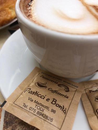 a cup of coffee sitting on top of a plate at Lemon Tree Boutique Guest House in Todi