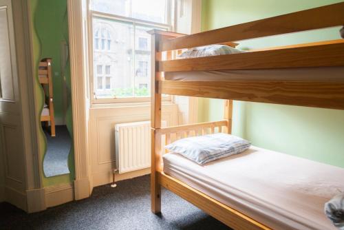 a bunk bed in a room with a window at Dundee Backpackers Hostel in Dundee