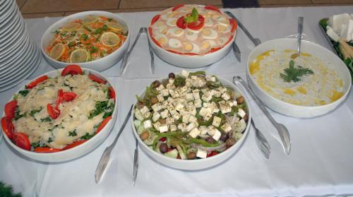 a table with four bowls of food on it at Golden View in Poros