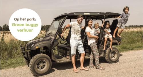 a group of people standing in front of a golf cart at Cosy Cabin - 4 pers in Zuna