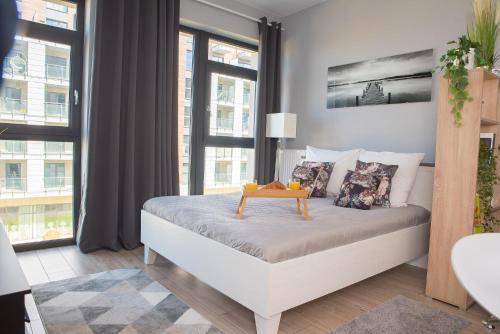a bedroom with a bed with a table on it at Easy Rent Apartments - BUSINESS CENTER 126 in Lublin