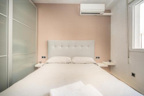 a white bedroom with a large white bed in it at Mar Apartment in Altea