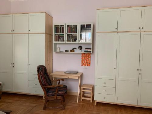 a room with white cabinets and a desk and a chair at Borjomi Central Park Apartment in Borjomi