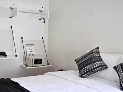 a bedroom with a bed with a clock on the wall at Hotel CasaDeTodos in Santiago