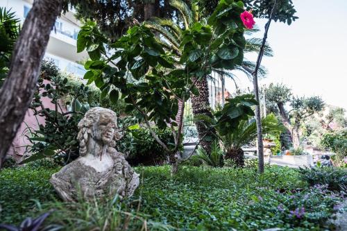 a statue of a woman sitting in the grass at Hotel Villino Gallodoro in Taormina