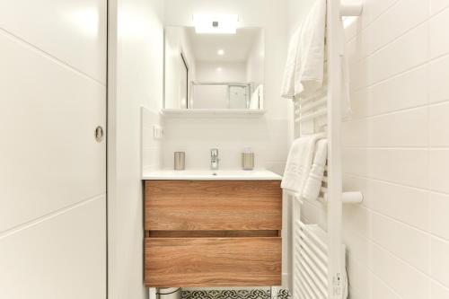 a bathroom with a sink and a mirror at VILLA14 in Dijon