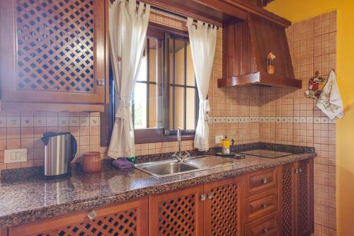 a kitchen with a sink and a window at Casa Chinamada in Las Lagunas