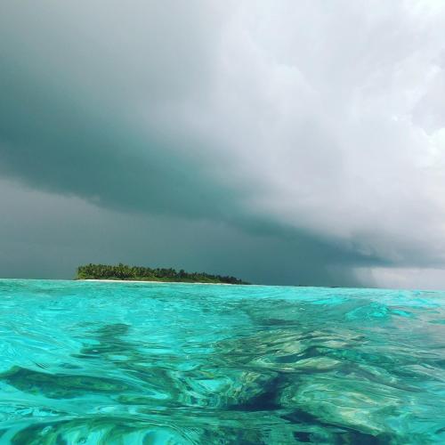 an island in the middle of a body of water at RISING SUN BEACH VIEW in Thinadhoo