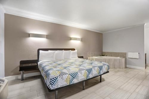 a bedroom with a bed and a desk in it at Motel 6-Lodi, CA in Lodi