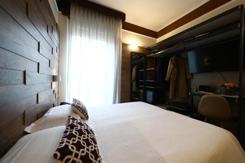 a hotel room with a bed and a window at Hotel Italia in Verona