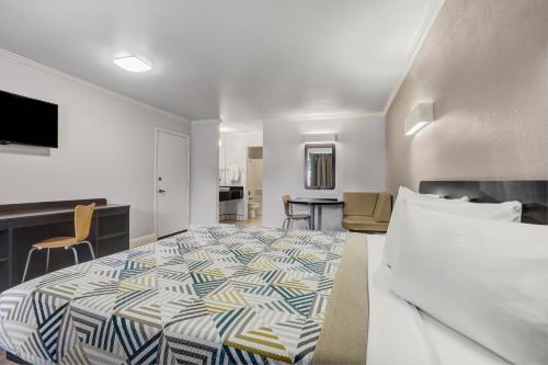 a bedroom with a bed and a living room at Motel 6-Lodi, CA in Lodi