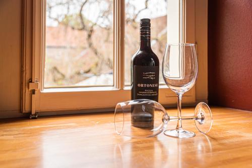 a bottle of wine sitting next to a wine glass at Landgoed Kasteel Limbricht in Limbricht
