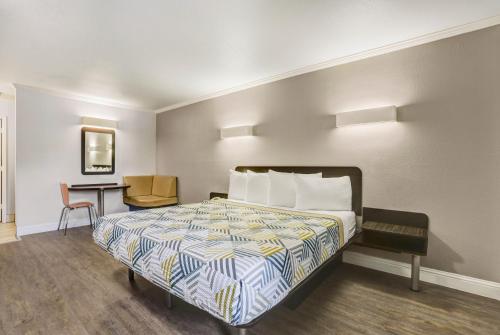 a hotel room with a bed and a desk at Motel 6-Lodi, CA in Lodi