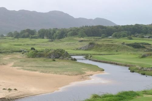 a view of a golf course with a river at Leenan View Country House in Portsalon