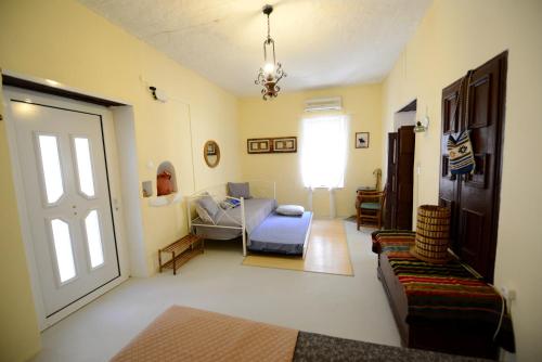 a living room with a couch and a window at Traditional Cretan Country House (9klm from Elafonissi) in Plokamianá