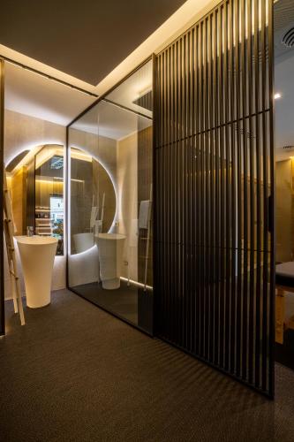 a bathroom with a toilet and a sink at HOTIDAY Room Collection - Olbia Wallure in Olbia