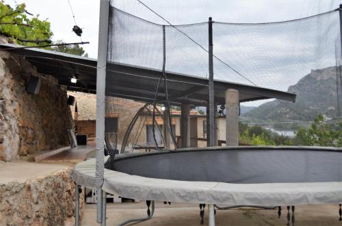 a large tub sitting outside of a building at Mas del Fangaro in Benifallet