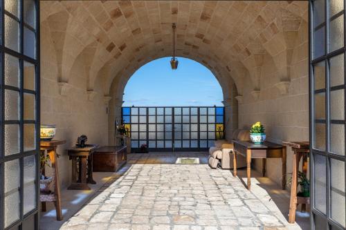 an archway in a building with a stone floor at Relais Borgo Segine in Melendugno