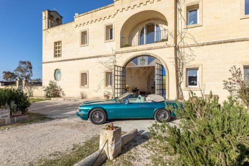 a blue car parked in front of a building at Relais Borgo Segine in Melendugno