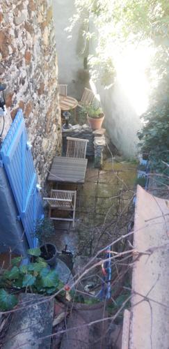 a patio with two benches and a blue fence at Gîtes chez Daniel "Cevennes 2" in Mars