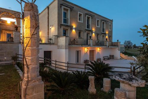 a large white building with lights on top of it at Relais Borgo Segine in Melendugno