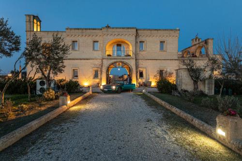 a car parked in front of a building at night at Relais Borgo Segine in Melendugno