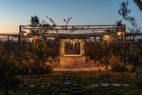 a house with a gate and lights in a yard at Relais Borgo Segine in Melendugno