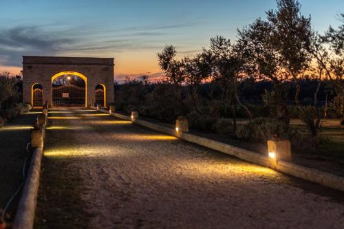 a building with lights on the side of a road at Relais Borgo Segine in Melendugno