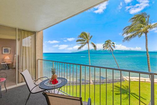 a balcony with a table and chairs and the ocean at Royal Kahana 309 1 Bedroom Condo condo in Kahana