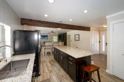 a kitchen with a black refrigerator and a counter top at Heated Pool Home - Close to Beaches, Restaurants & More! in Sarasota