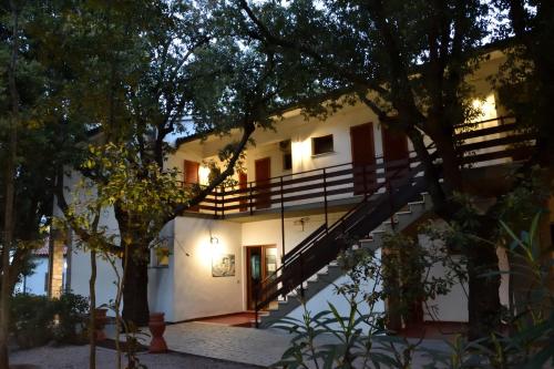 a house with stairs leading up to the front of it at Eden Park Hotel in Marina di Campo