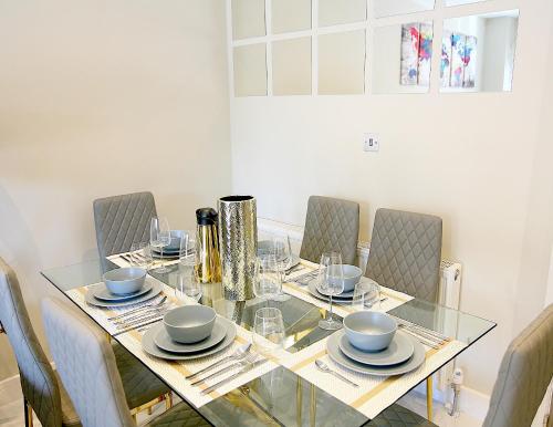 a dining room table with chairs and a glass table top at NEW - Stylish 2 bed, Farnham Common in Hedgerley