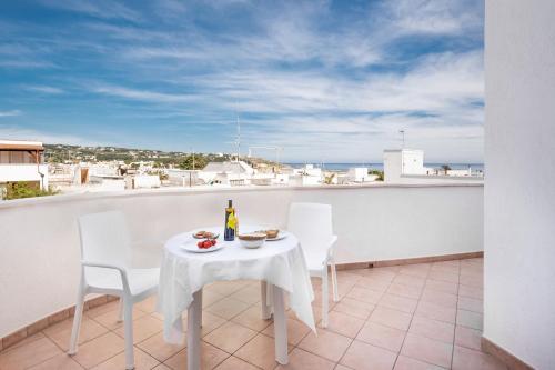 a white table and chairs on a balcony with a view at Residence Bellevue in Leuca