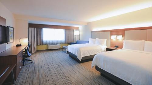 a hotel room with two beds and a flat screen tv at Holiday Inn Express Lompoc by IHG in Lompoc