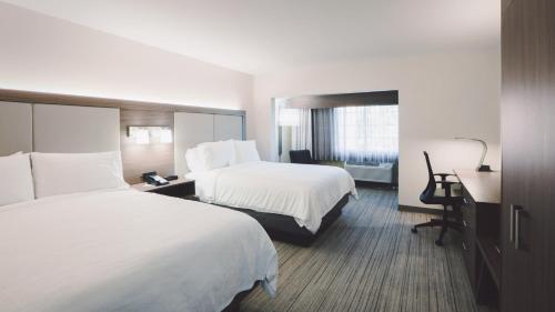 a hotel room with two beds and a desk at Holiday Inn Express Lompoc by IHG in Lompoc