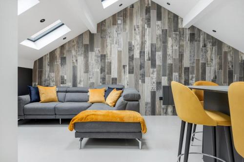 a living room with a couch and a table and chairs at Winter Garden Apartments by Sasco in Blackpool