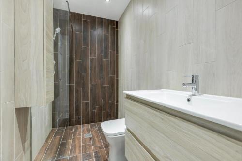 a bathroom with a sink and a toilet at Winter Garden Apartments by Sasco in Blackpool