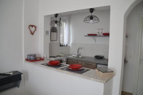 a kitchen with two red bowls on a counter at A Place to Relax 2 in Nisakion