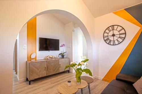 a living room with a clock on the wall at vita nova in Santa-Maria-di-Lota