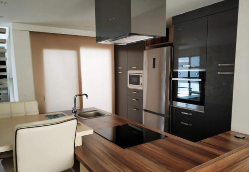 a kitchen with black cabinets and a counter top at Exclusive Villas in Kusadası