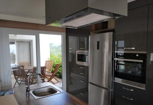 a kitchen with a stainless steel refrigerator and a sink at Exclusive Villas in Kusadası