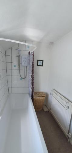 a small bathroom with a shower in a room at Cornerstones Cottage, Tideswell in Tideswell