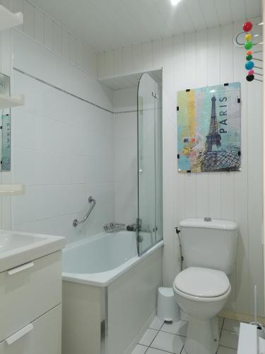 une salle de bain blanche avec toilettes et baignoire dans l'établissement Résidence d'Azur 2 appartement 311, au Lavandou