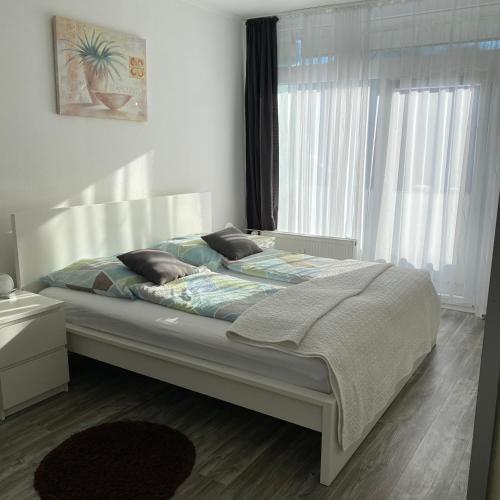 a bedroom with a bed in a room with a window at International in Bad Harzburg