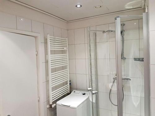 a white bathroom with a shower and a toilet at fewo1846 Intermar - Kajuete Foerdeblick - familienfreundliches Studioapartment mit Balkon und Meerblick in Glücksburg