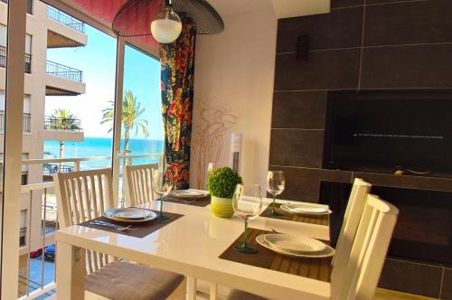 a dining room with a table with a view of the ocean at Carmen apartments with sea view near Alicante in Santa Pola