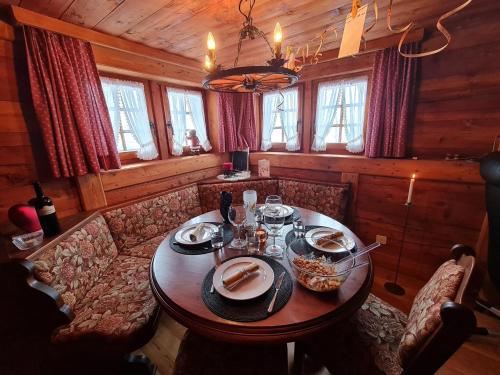 a dining room with a table in a cabin at Atelier 1786 in Staldenried