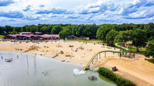 an aerial view of a beach with a playground at Mijn Chalet in Erm