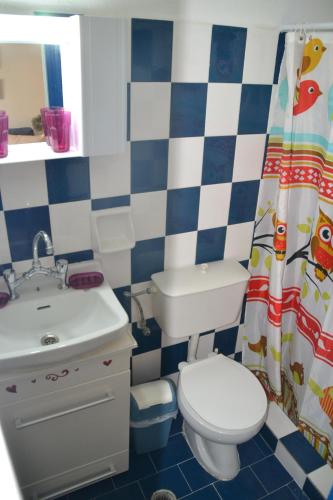 a bathroom with a toilet and a sink at A Place to Relax 1 in Nisakion